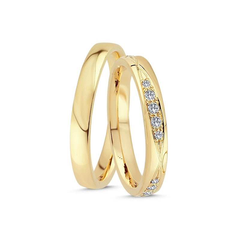 Eksklusive Nuran vielsesringe i 14 karat guld med 0,26 ct hvide diamanter og let buet profil.